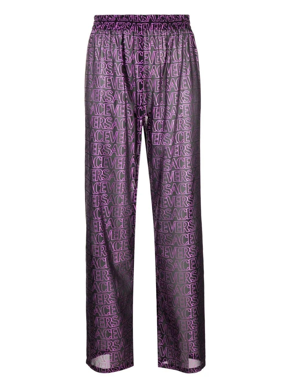 VERSACE BLACK SEMI-TRANSPARENT TROUSERS WITH PINK LOGO PRINT