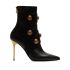 Black ankle boots embellished with gold embossed buttons