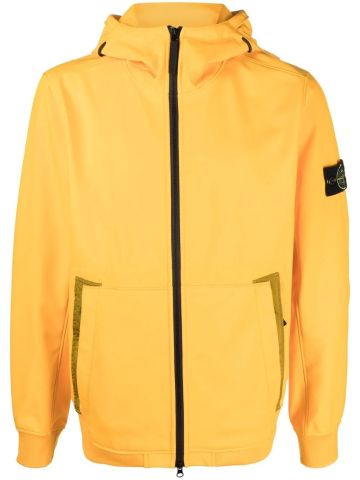Yellow windbreaker jacket with hood and compass logo