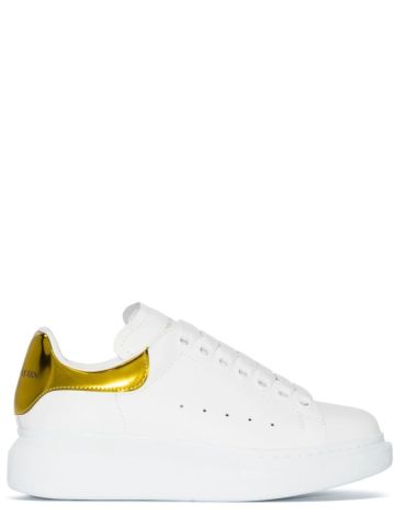 White oversized trainers with metallic yellow contrast detail