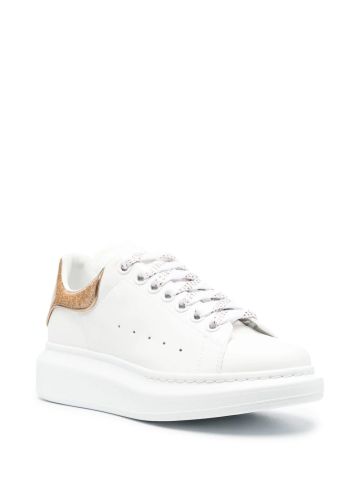 White oversized trainers with gold glitter detailing