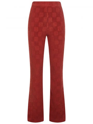 High-waisted flared trousers in rust brown velvet with monogram motif