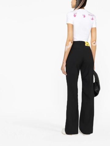 Black tailored trousers with yellow logo patch on the back
