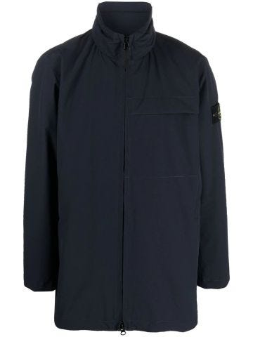 Blue windbreaker jacket with high collar and Compass logo application