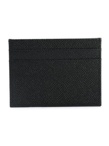 Black leather card holder with gold logo plaque