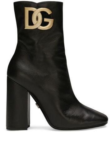 Black boots with gold logo plaque