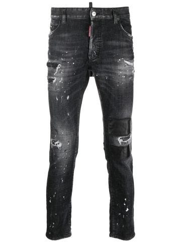Black tapered jeans with white paint detail