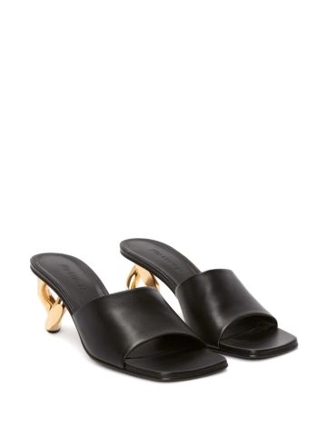 Black mules with gold sculpted heel