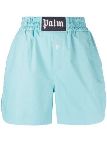 Light blue sports shorts with waistband appliqué