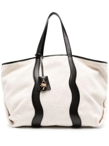 Beige tote bag with logo plaque and black leather trim